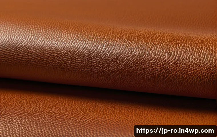 콤부차 가죽의 바이오 소재로서의 가능성 - A close-up detailed shot of kombucha leather texture showcasing its unique balance of softness and d...